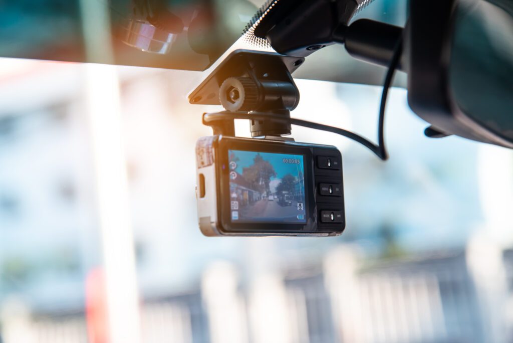 Car video camera attached to the windshield to record driving.